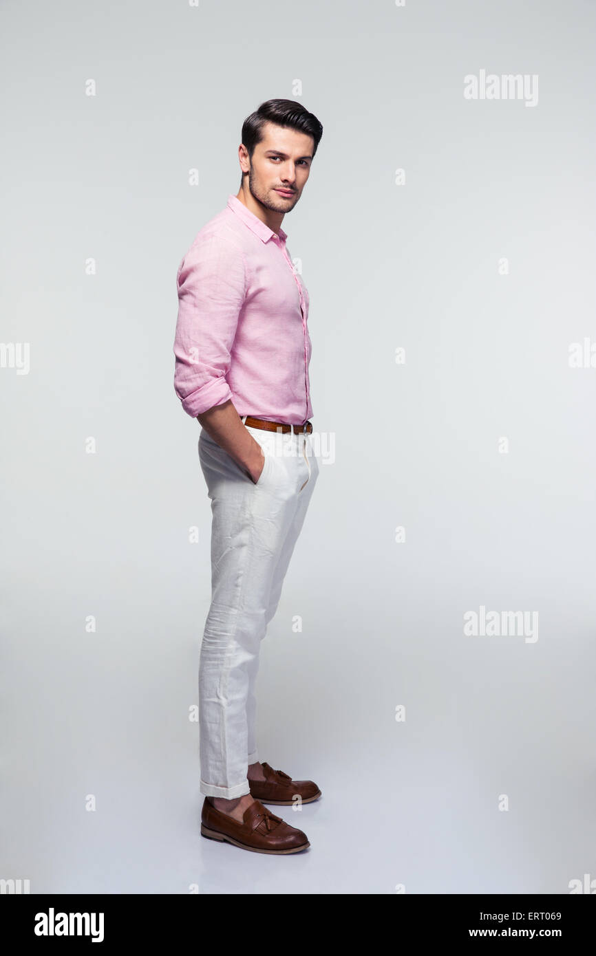 Full length portrait of a handsome young businessman looking at camera ...