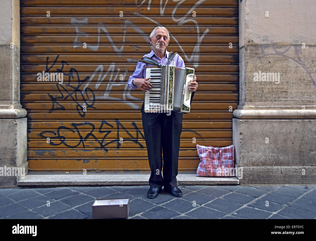 An accordion player performing on the street in the city center Stock ...