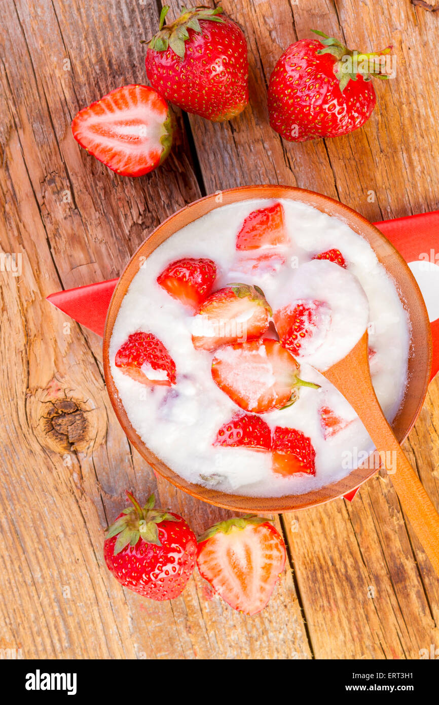 strawberry and yogurt in a wooden bowl on wooden background Stock Photo