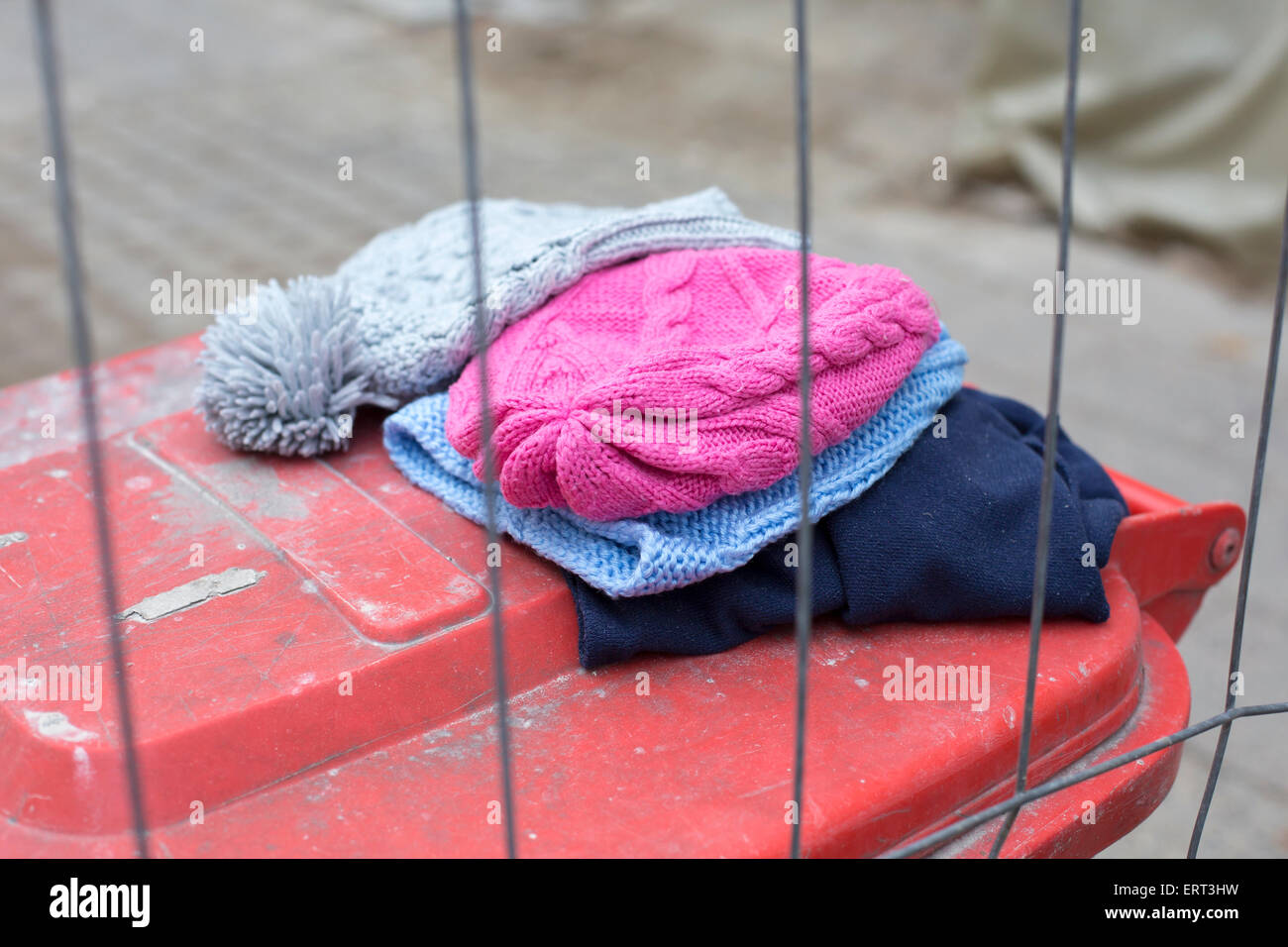 wool hats lying on top of a trashcan Stock Photo