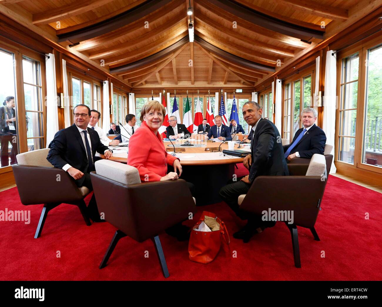 Elmau Castle, Germany. 8th June, 2015. Garmisch-Partenkirchen, Germany. 08th June, 2015. (Clockwise from L) French President Francois Hollande, British Prime Minister David Cameron, Italy's Prime Minister Matteo Renzi, European Commission President Jean-Claude Juncker, European Council President Donald Tusk, Japanese Prime Minister Shinzo Abe (obscured) Canada's Prime Minister Stephen Harper, US President Barack Obama and Germany's Chancellor Angela Merkel, attend working meeting at the G7 summit at Elmau Castle hotel in Elmau near Garmisch-Partenkirchen, Germany, 08 June 8 2015. © dpa picture Stock Photo