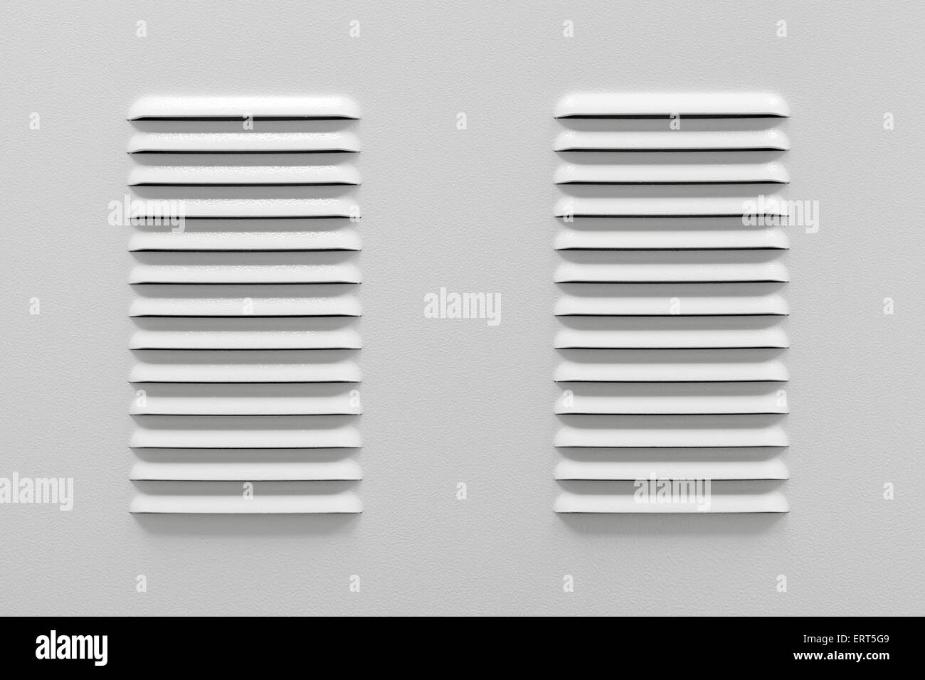White metal industrial panel with ventilation grilles, closeup photo, front view Stock Photo