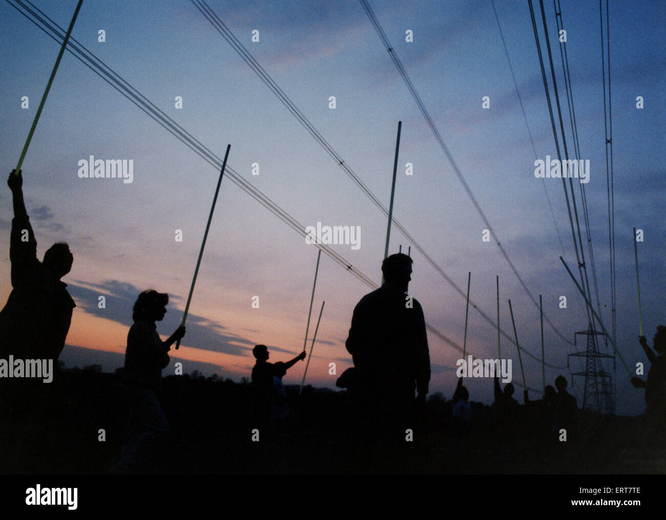 Pylon protestors make their point with fluorescent tubes lit by standing under a pylon. 14th
