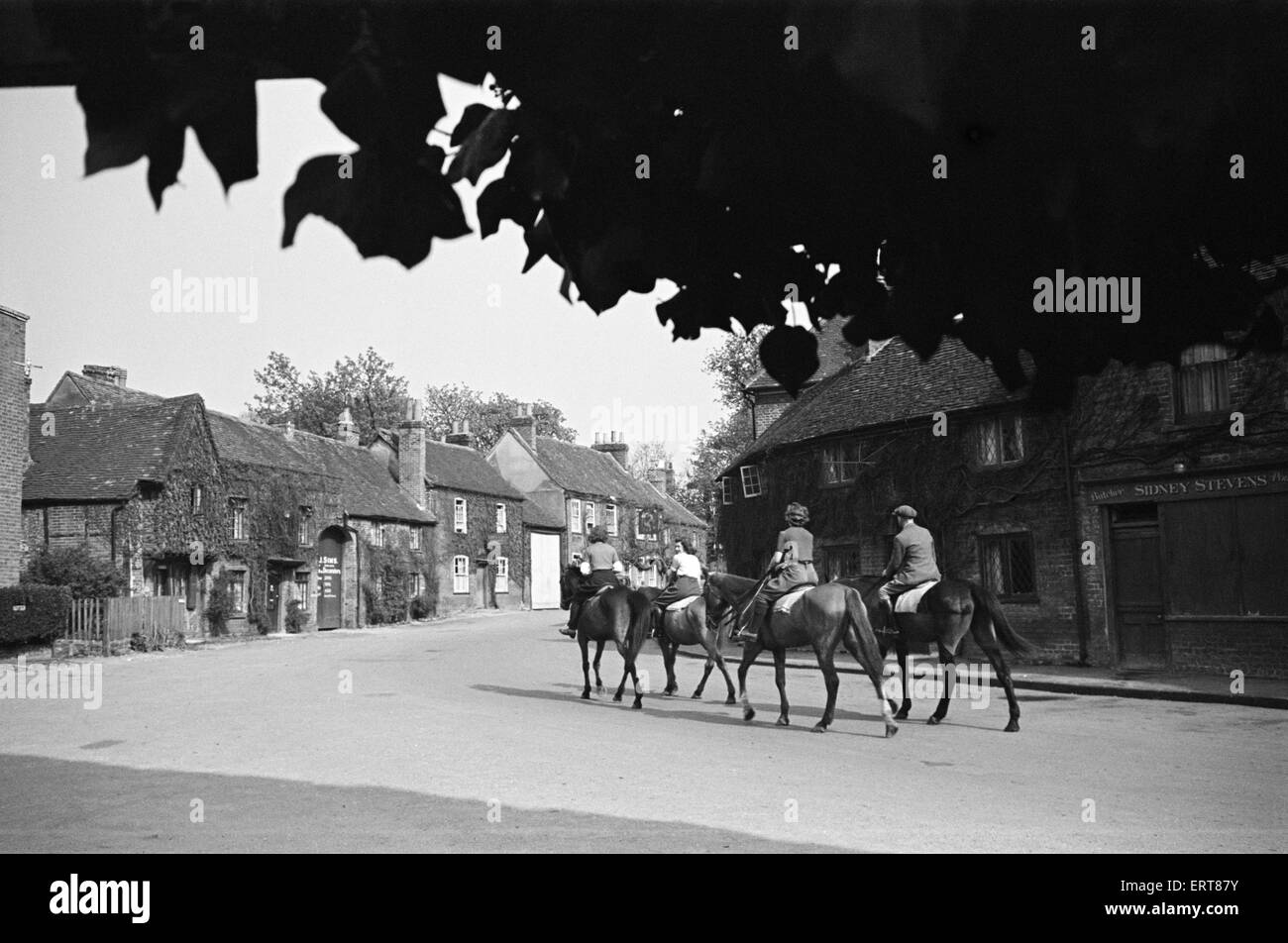 Women riding on horses down Village Road, Denham, Buckinghamshire