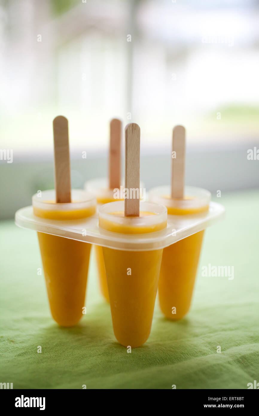 Yellow popsicles with tropical fruit Stock Photo Alamy
