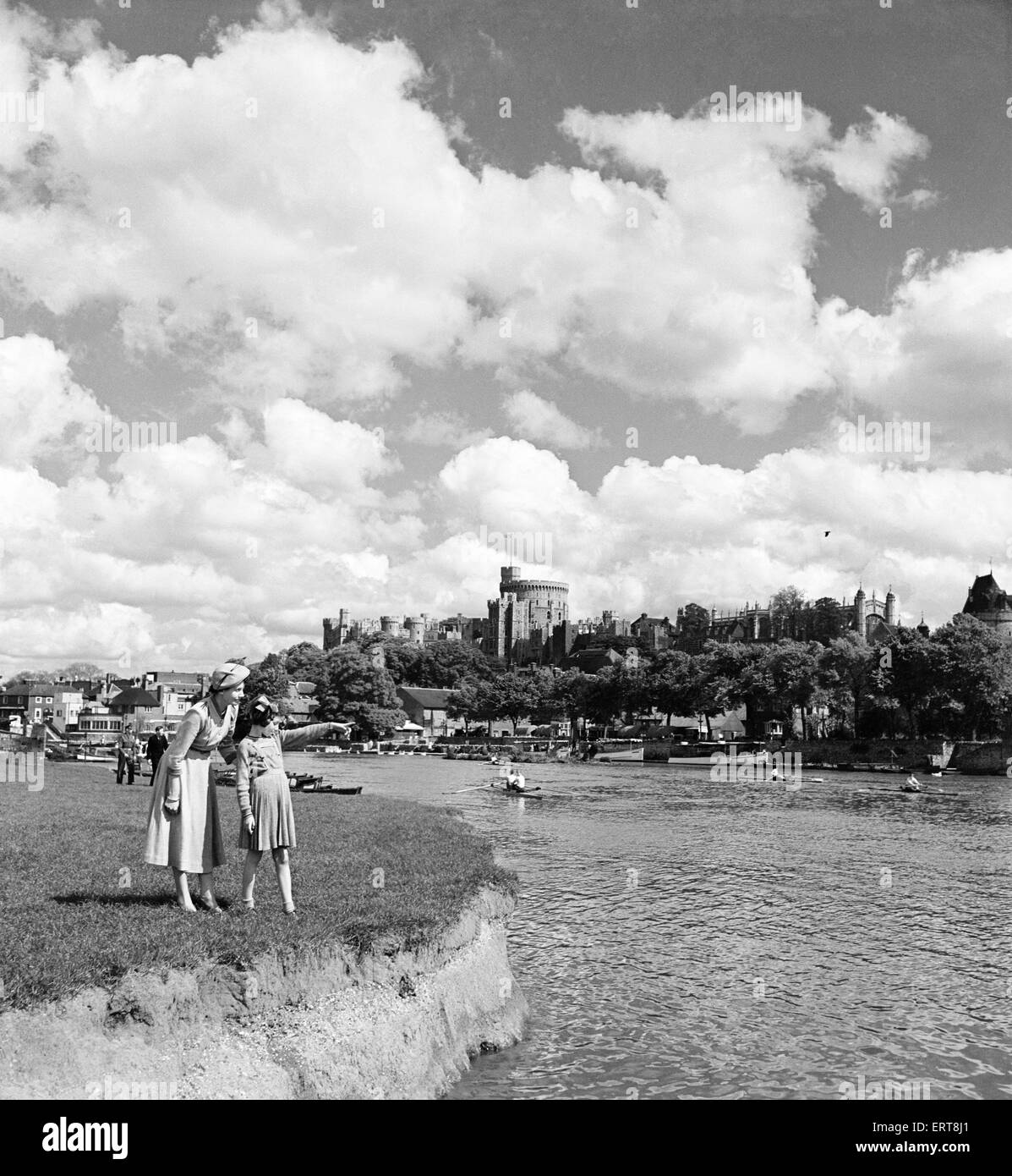 A woman and a young girl looking across the River Thames, with Windsor Castle in the background, Berkshire, 1st May 1952. Stock Photo