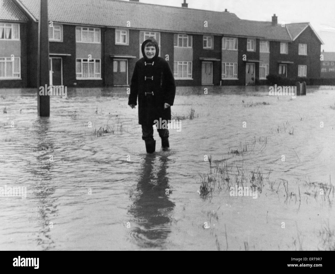 A local resident of Brambles Farm Middlesbrough makes their way through the flood water 2nd November 1968 Stock Photo
