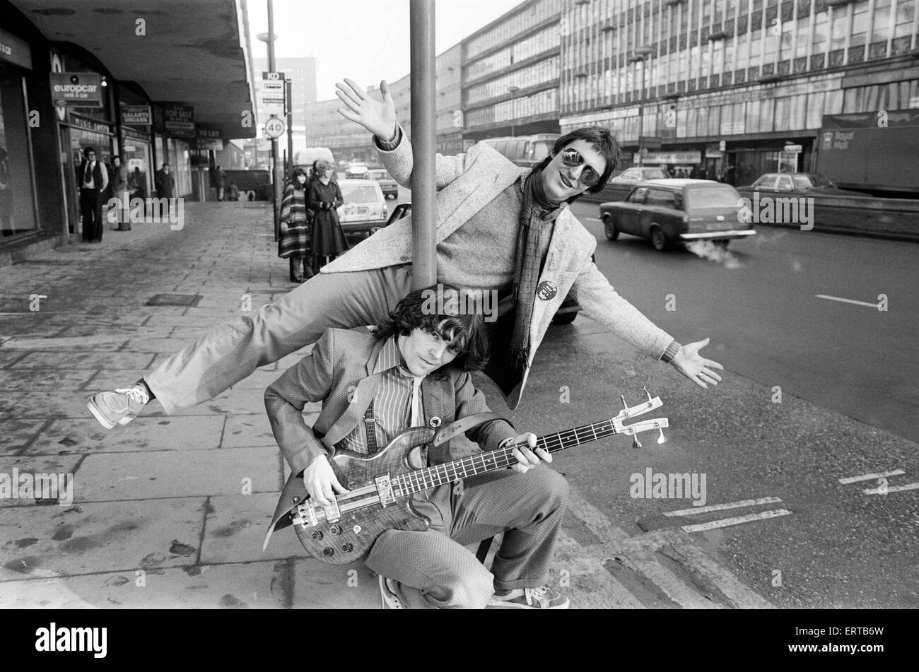Guitarist Gerry Cott (standing) and bass player Peter Briquette from the Boomtown Rats visited Birmingham to make a trade presentation at a city music shop. 12th January 1979. Stock Photo