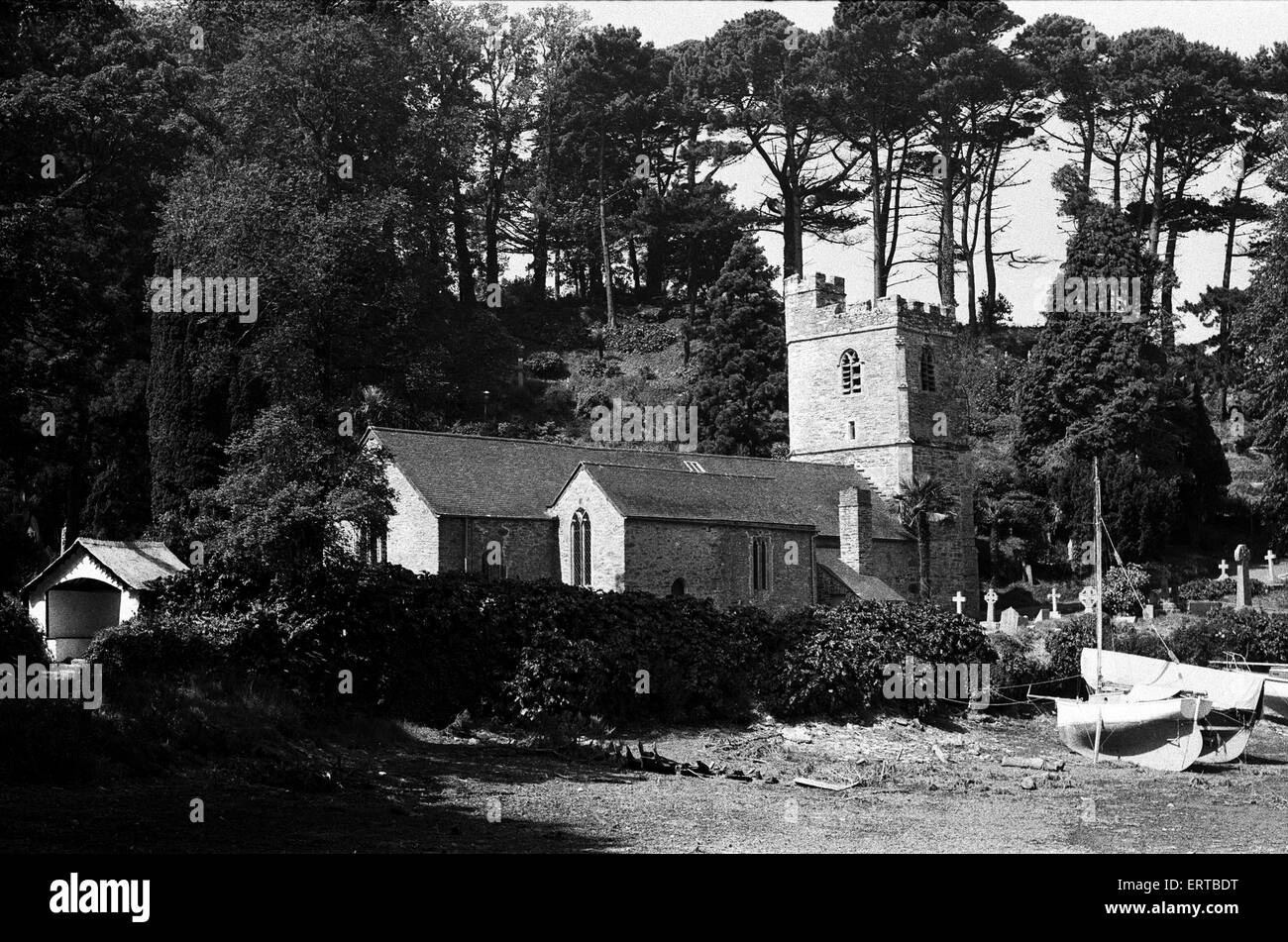 The 13th century St Just in Roseland Church, in St Just in Roseland, Cornwall. The church is set in set in riverside gardens luxuriantly planted with semitropical shrubs and trees, many of which are species rare in England. The village is situated six miles (10 km) south of Truro and two miles (3 km) north of St Mawes. June 1975. Stock Photo