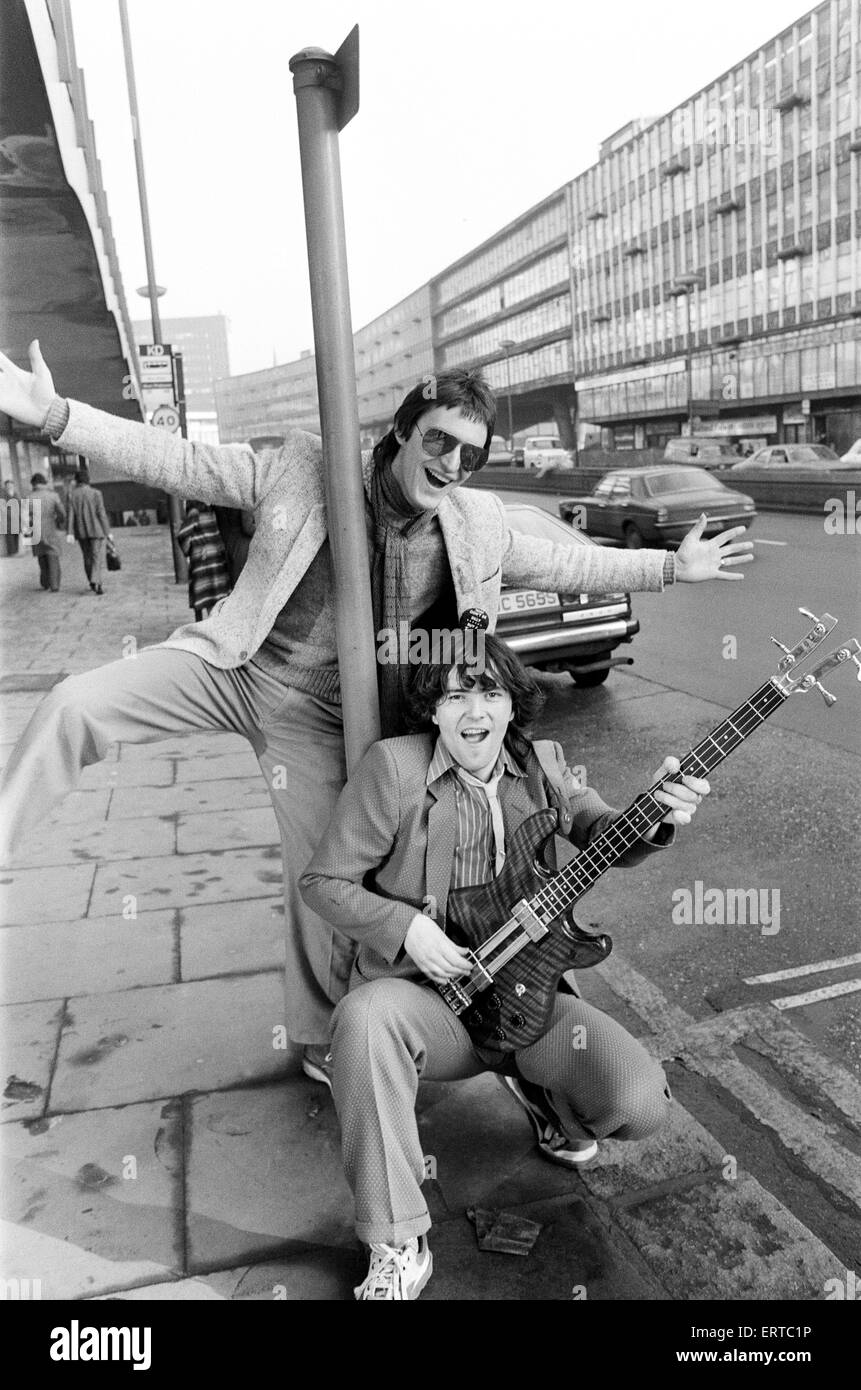Guitarist Gerry Cott (standing) and bass player Peter Briquette from the Boomtown Rats visited Birmingham to make a trade presentation at a city music shop. 12th January 1979. Stock Photo