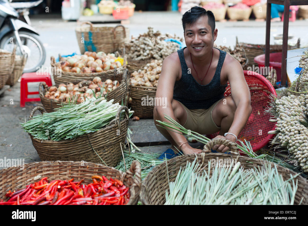 Asian man street market seller bunch green onion Stock Photo - Alamy