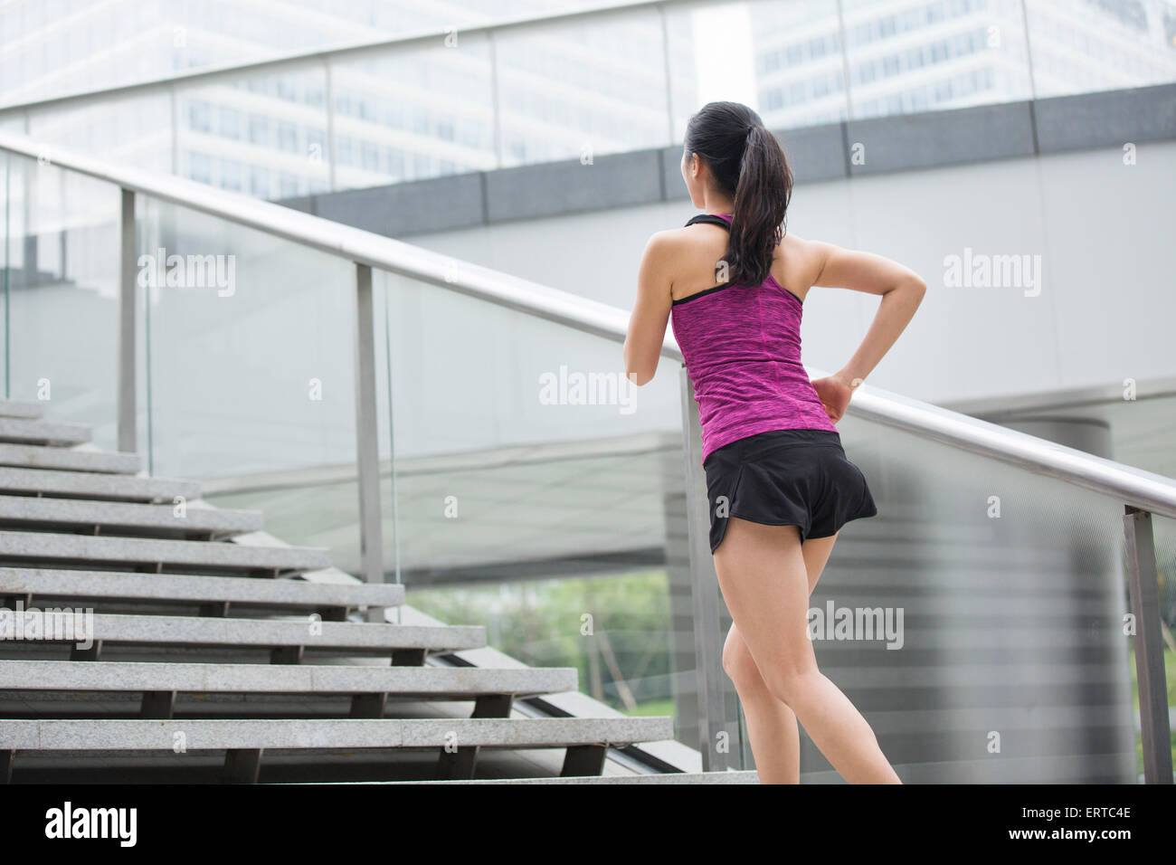 Young woman running up stairs for exercise Stock Photo Alamy