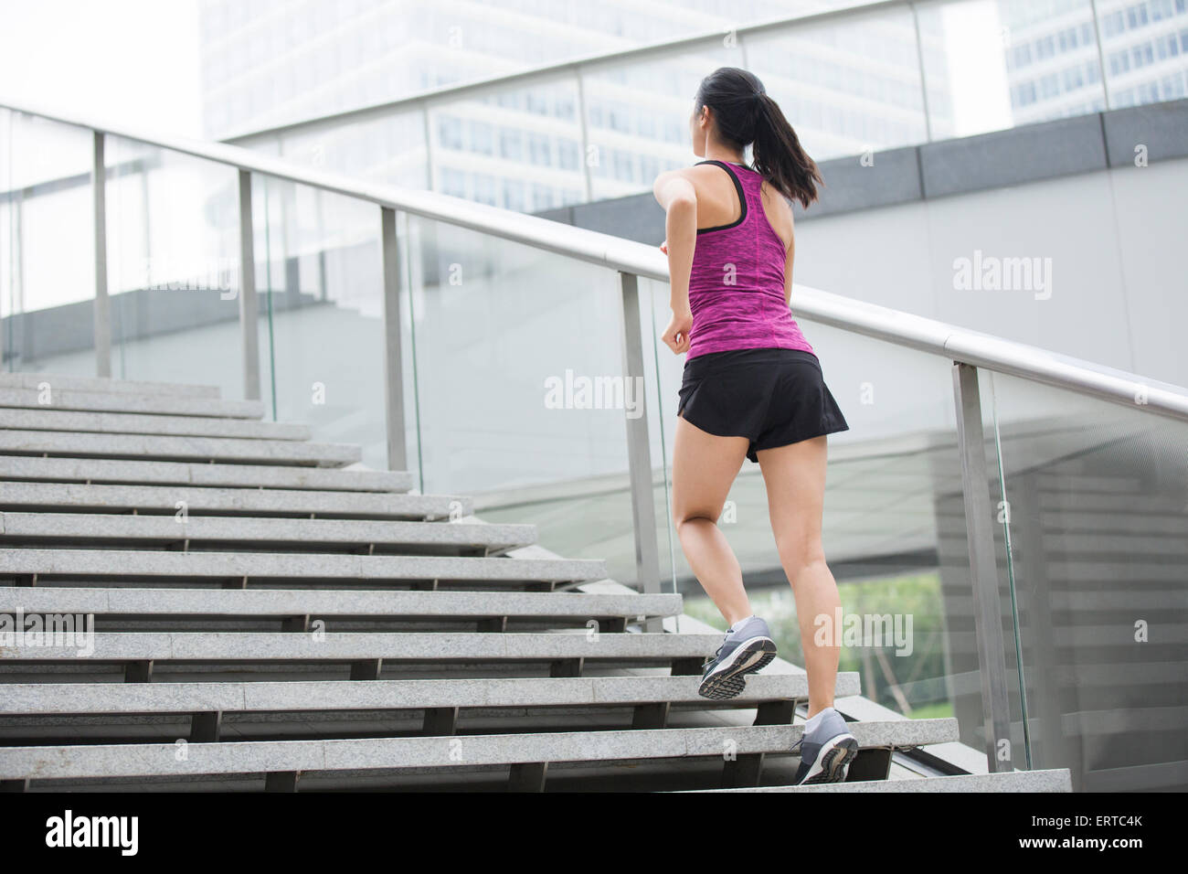 Young woman running up stairs for exercise Stock Photo Alamy