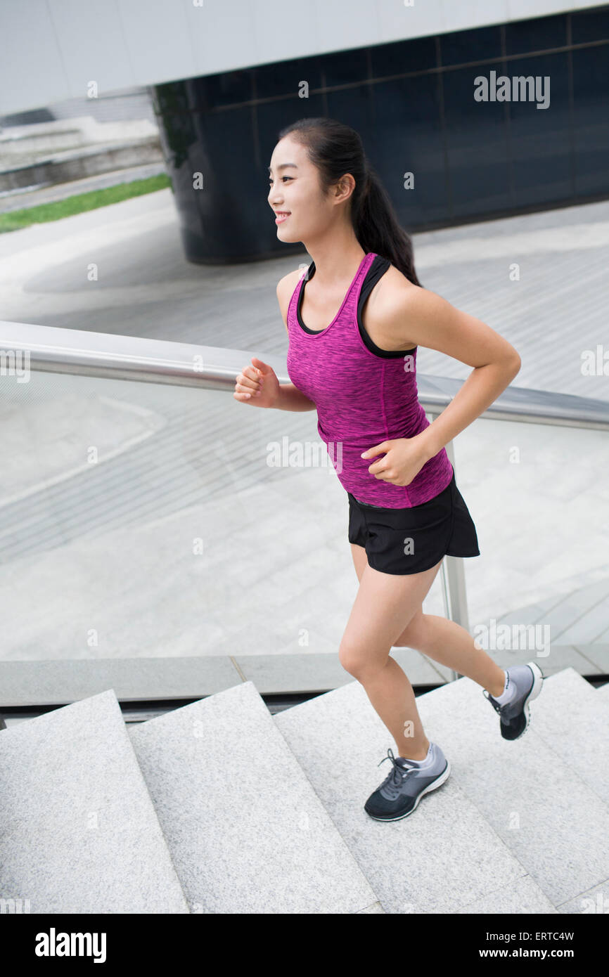 Young woman running up stairs for exercise Stock Photo Alamy