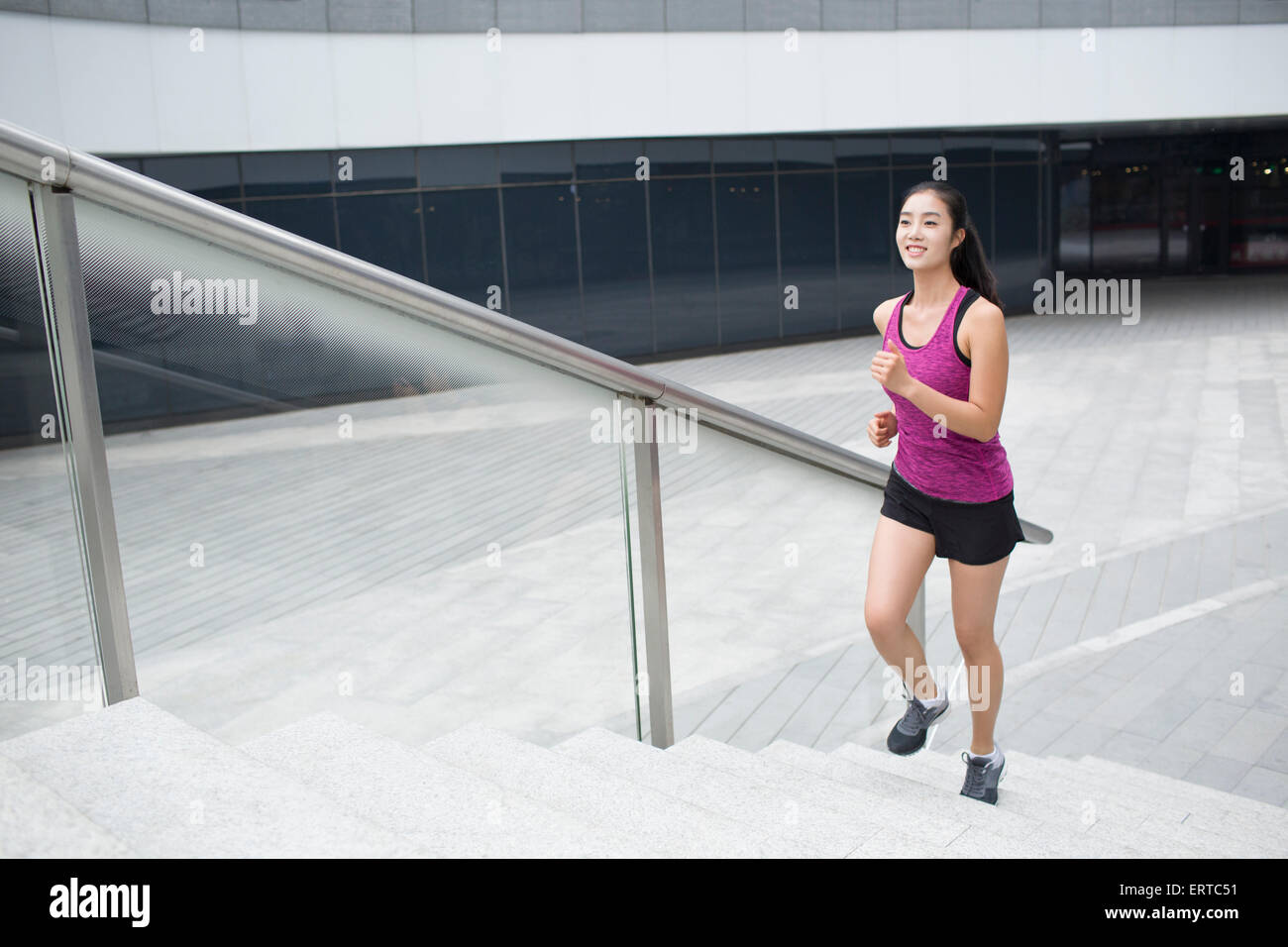Young woman running up stairs for exercise Stock Photo Alamy
