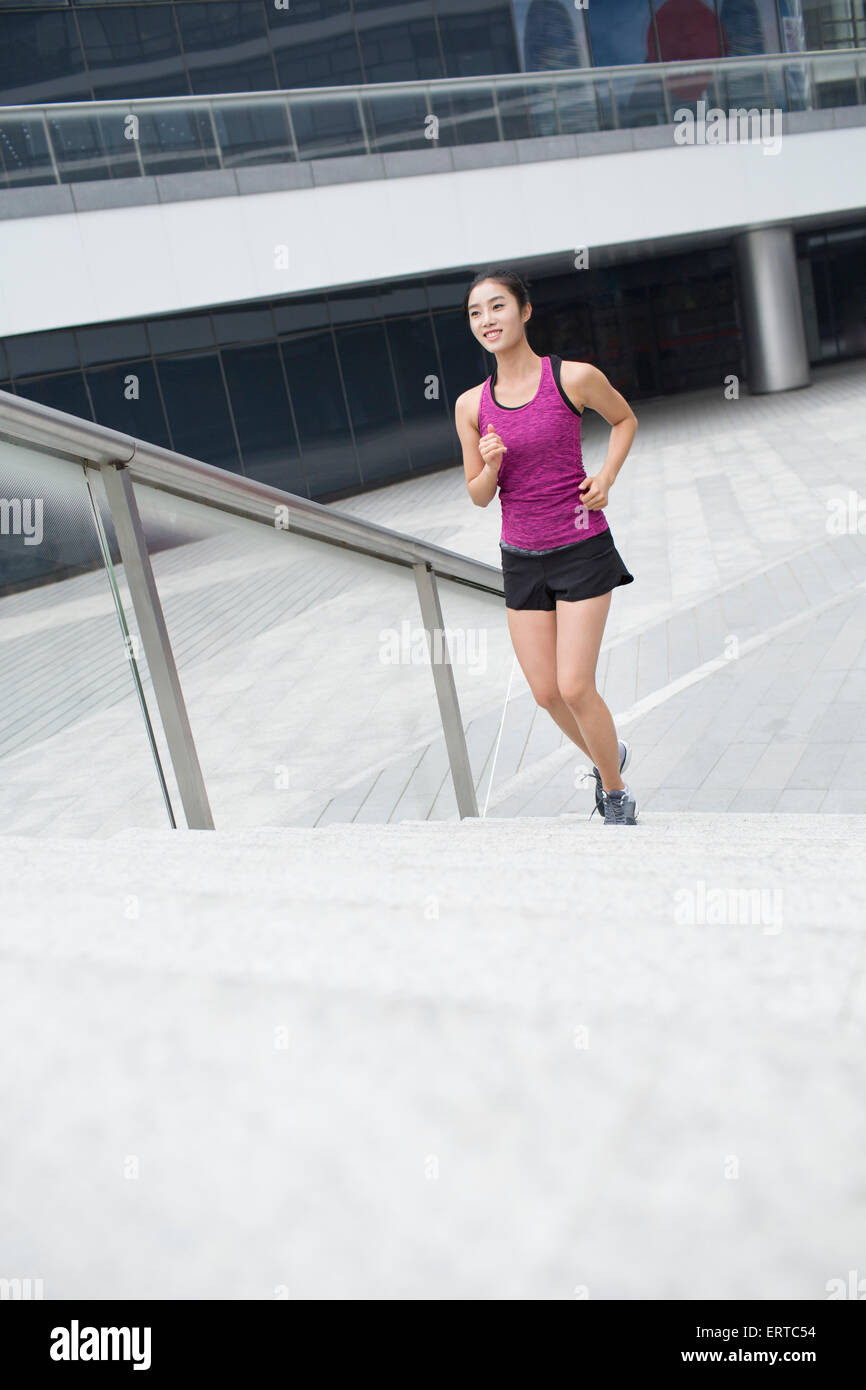 Young woman running up stairs for exercise Stock Photo Alamy