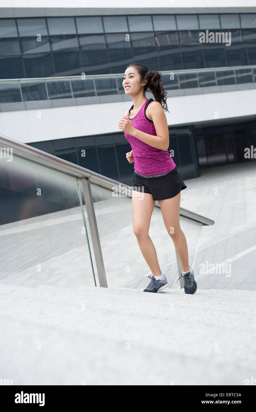 Young woman running up stairs for exercise Stock Photo Alamy