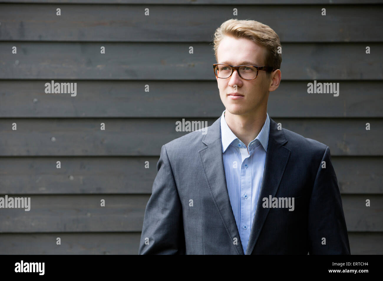 young blond man in a suit with glasses Stock Photo - Alamy