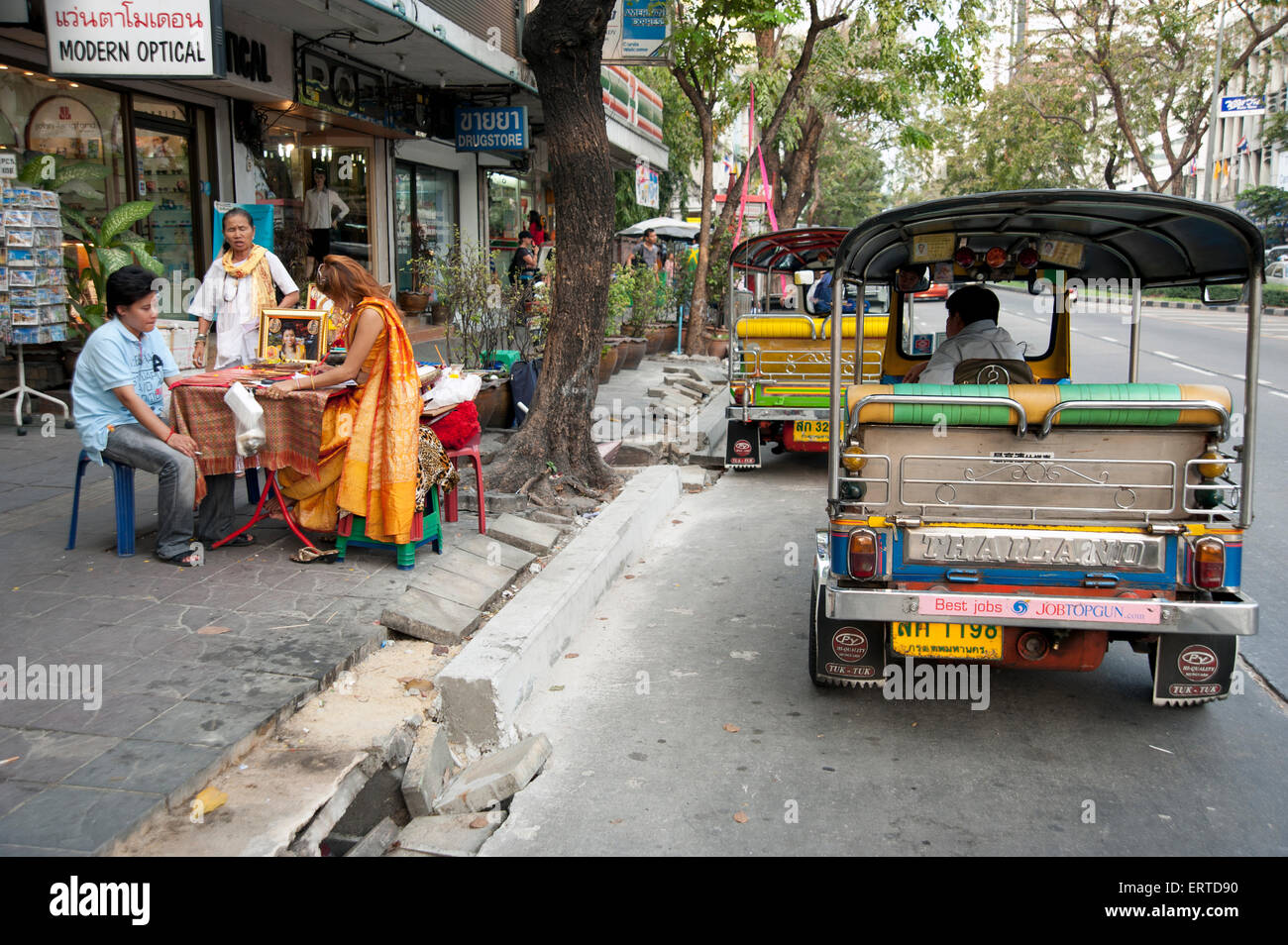 Silom road fortune teller and tuk tuks in bangkok hires stock