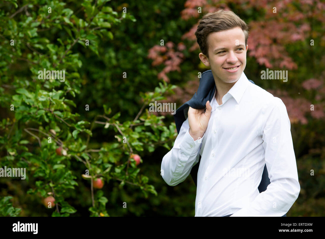 portrait of a young man in a suit outside and smiling Stock Photo - Alamy
