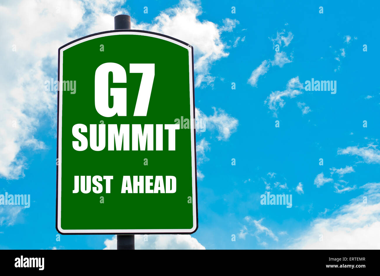 G7 SUMMIT Just Ahead written on green road sign  against clear blue sky background. Concept image with available copy space Stock Photo