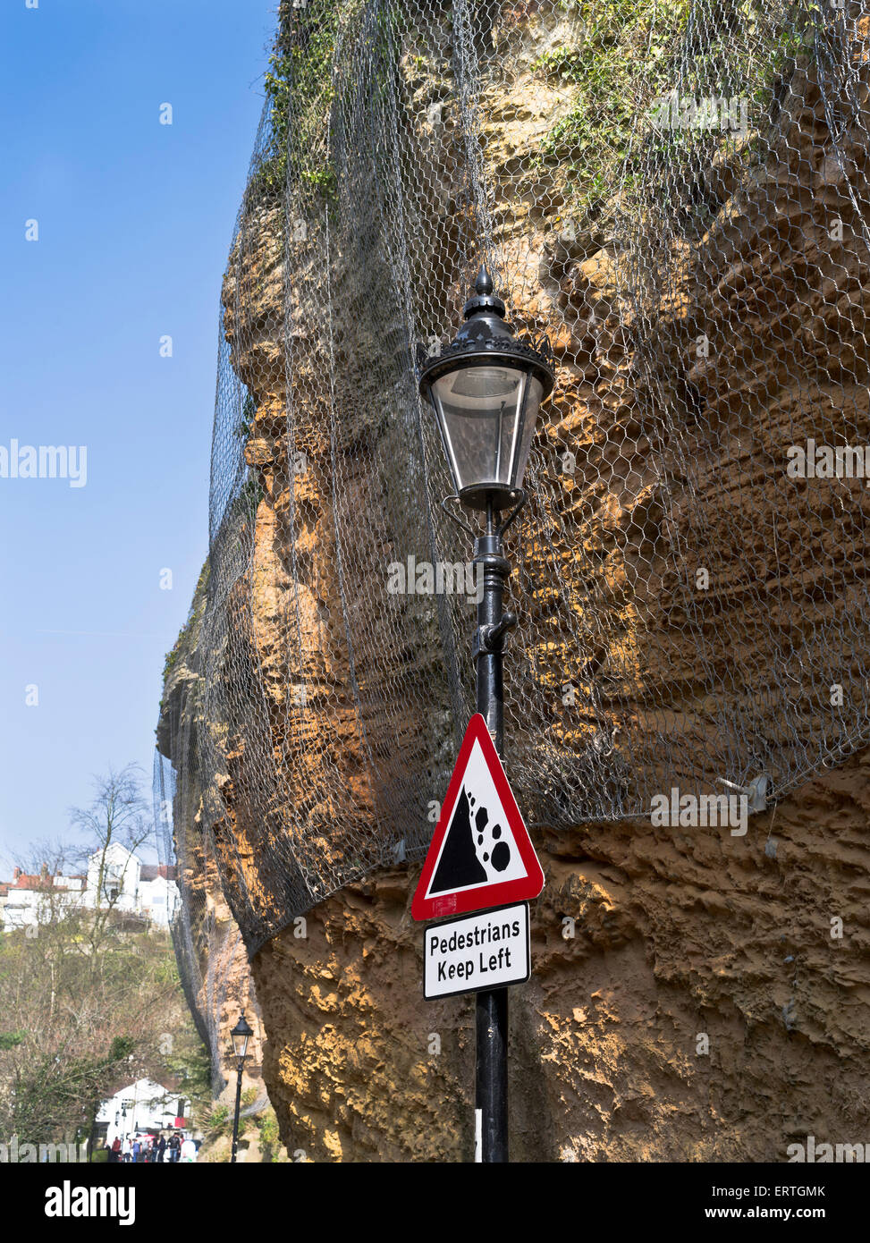 dh Cliff erosion ENVIRONMENT UK Warning sign of falling rocks cliff erosion wire mesh hazard triangle safety Stock Photo