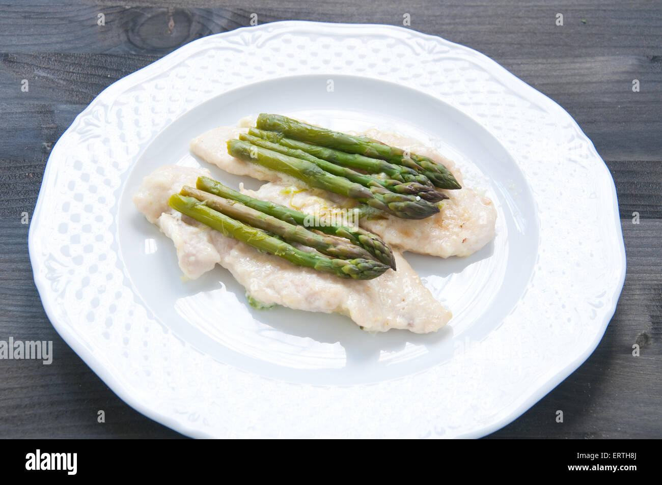 Veal cutlets cooked in butter with asparagus Stock Photo Alamy