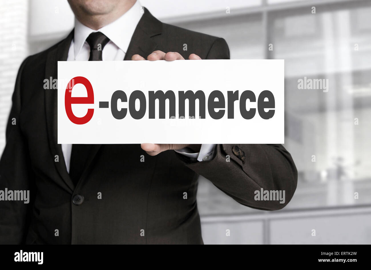 ecommerce sign held by businessman. Stock Photo