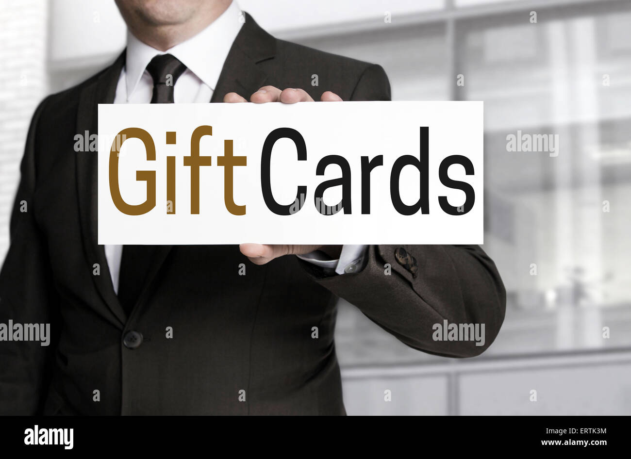 Gift Cards sign is held by businessman. Stock Photo