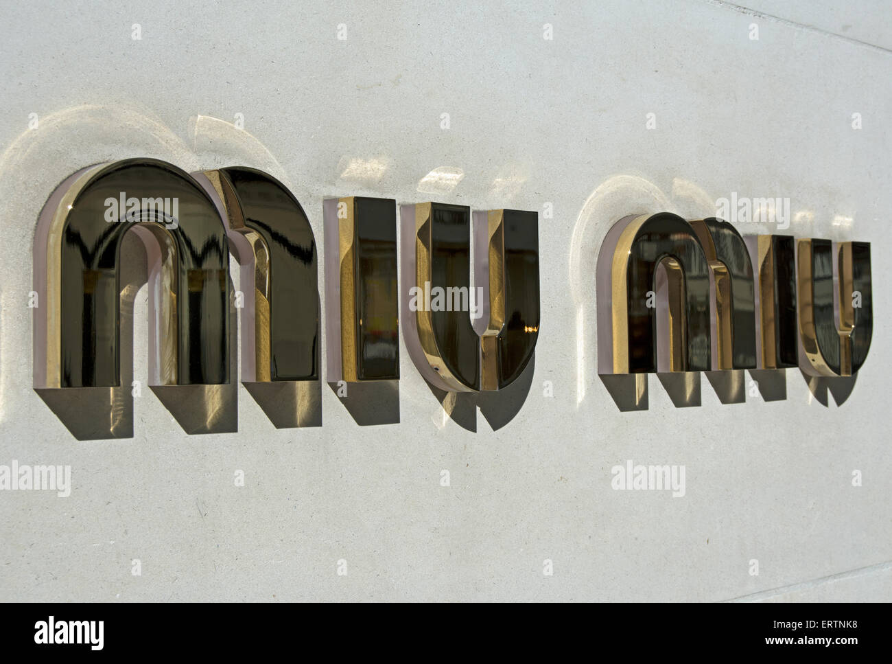 name of miu miu on exterior wall of a branch of the women's luxury fashion store on regent street, london, england Stock Photo