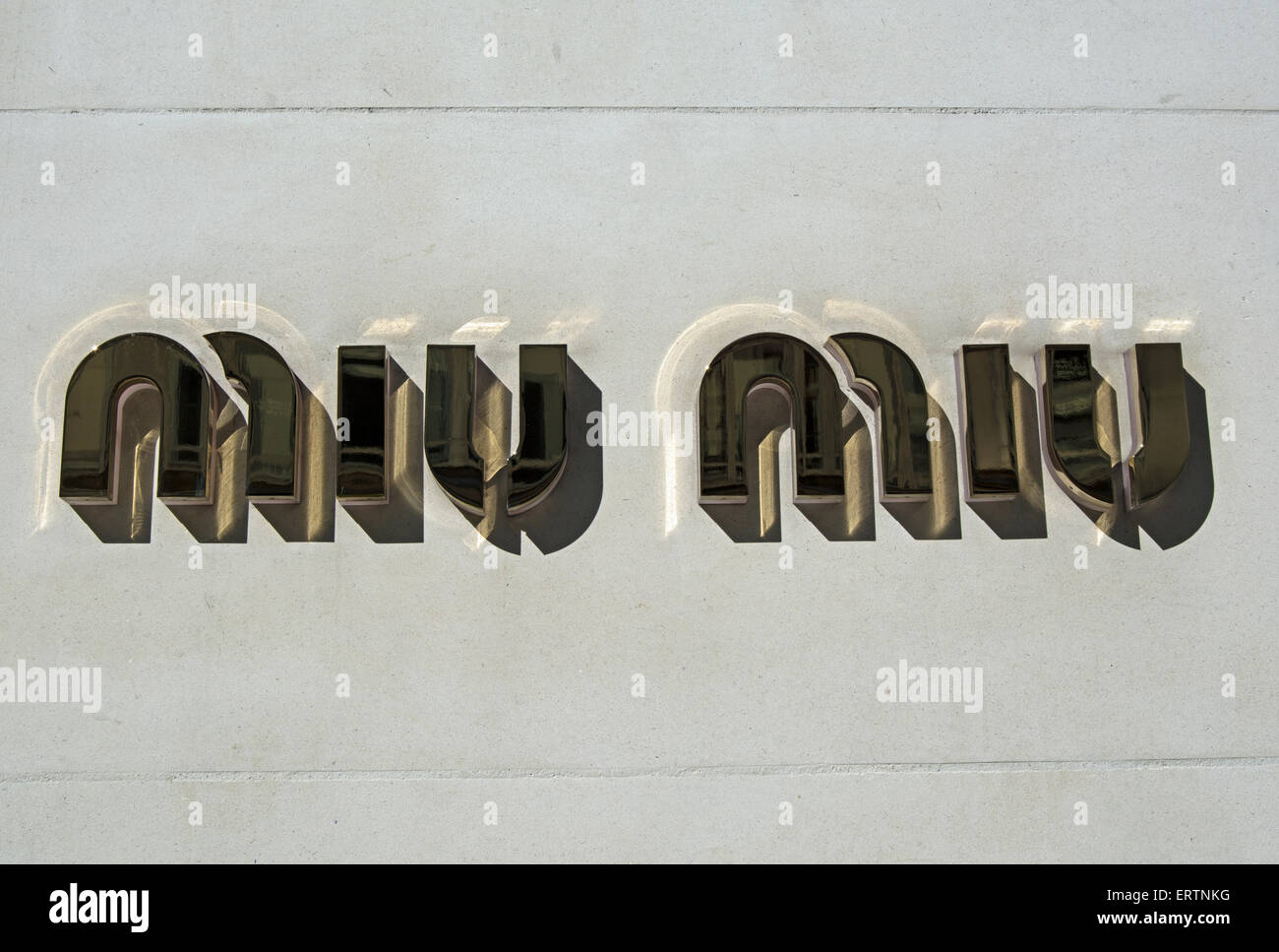 name of miu miu on exterior wall of a branch of the women's luxury fashion store on regent street, london, england Stock Photo