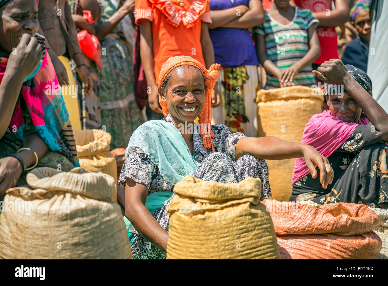 Ethiopian woman selling crops in a local crowded market. Stock Photo