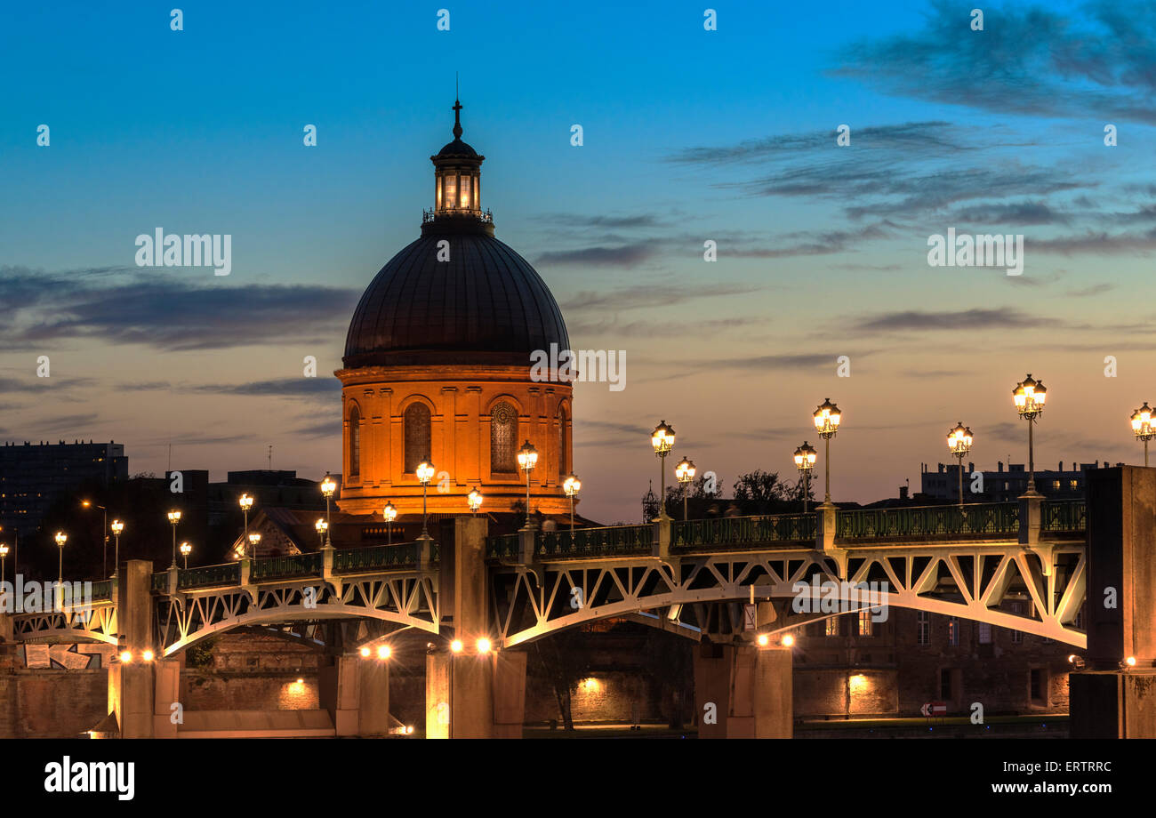 Toulouse, France - The dome of the Hopital de la Grave over St Pierre Bridge at night Stock Photo