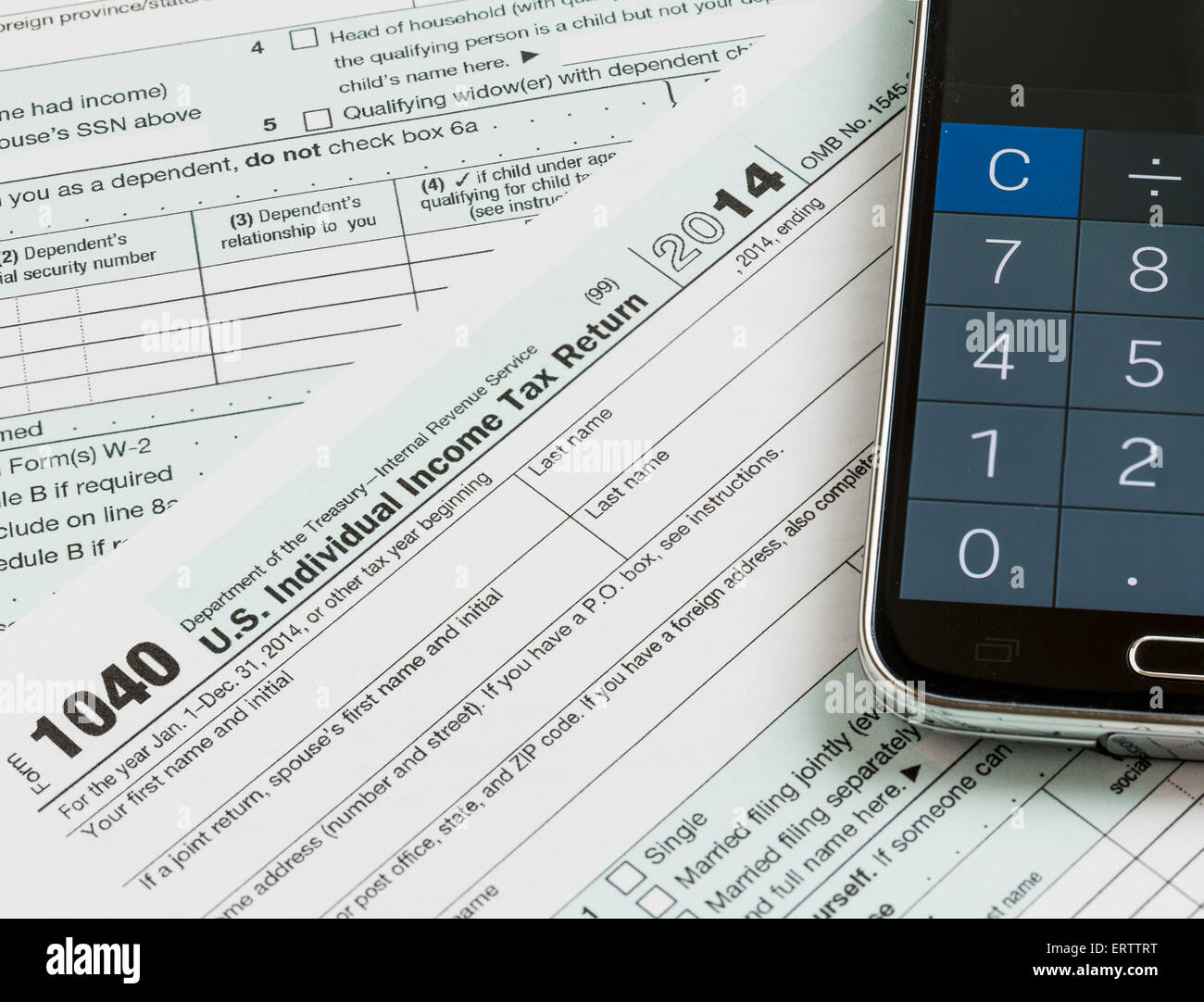 USA tax form 1040 with calculator app on phone Stock Photo