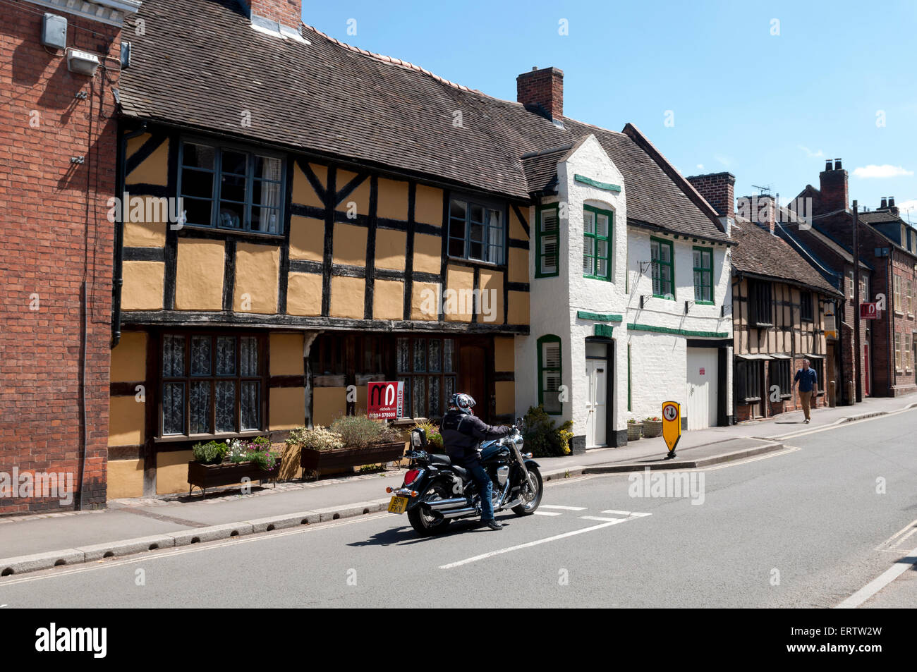 A motorcycle in High Street, Kinver, Staffordshire, England, UK Stock Photo
