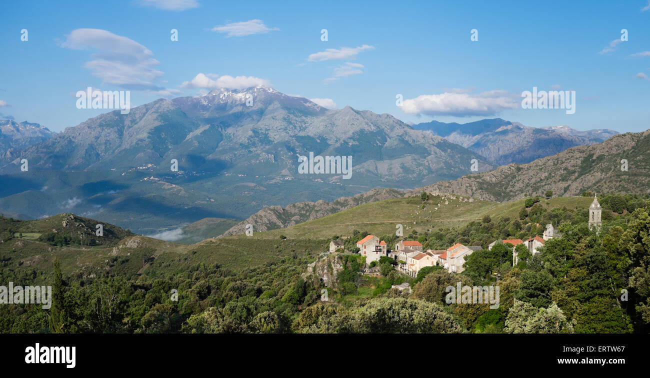 The mountain village of Sermanu with the high mountains beyond on a bright spring morning Stock Photo