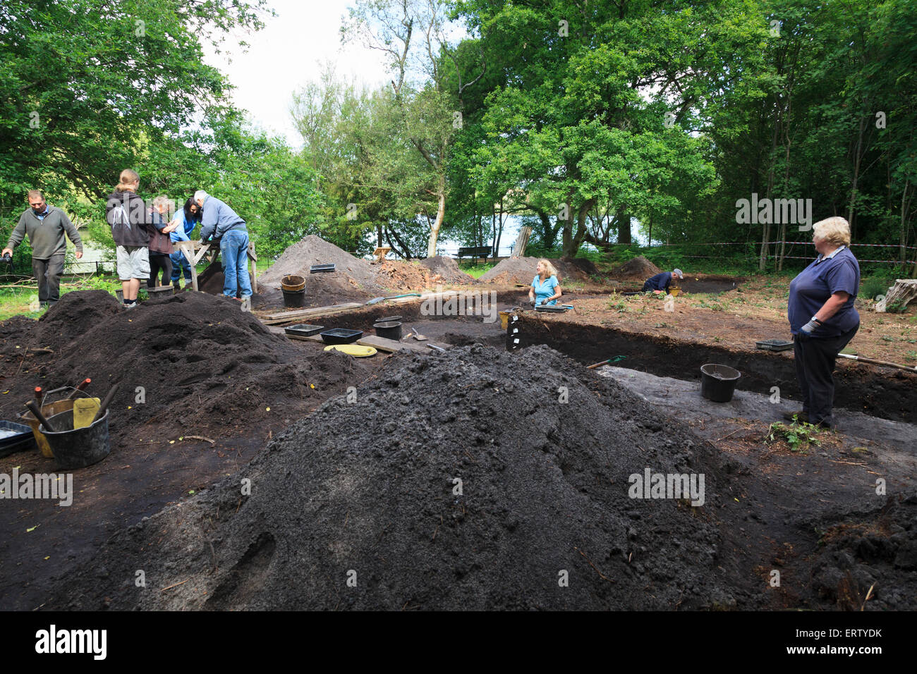 Archaeologists working on a Bronze Age excavation trench in a forest Stock Photo