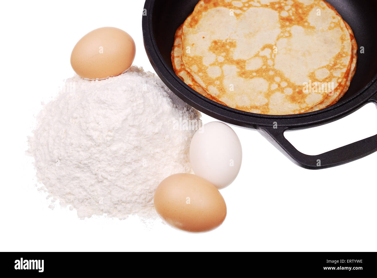 Pancake on a dripping pan, a handful flour, and eggs isolated Stock