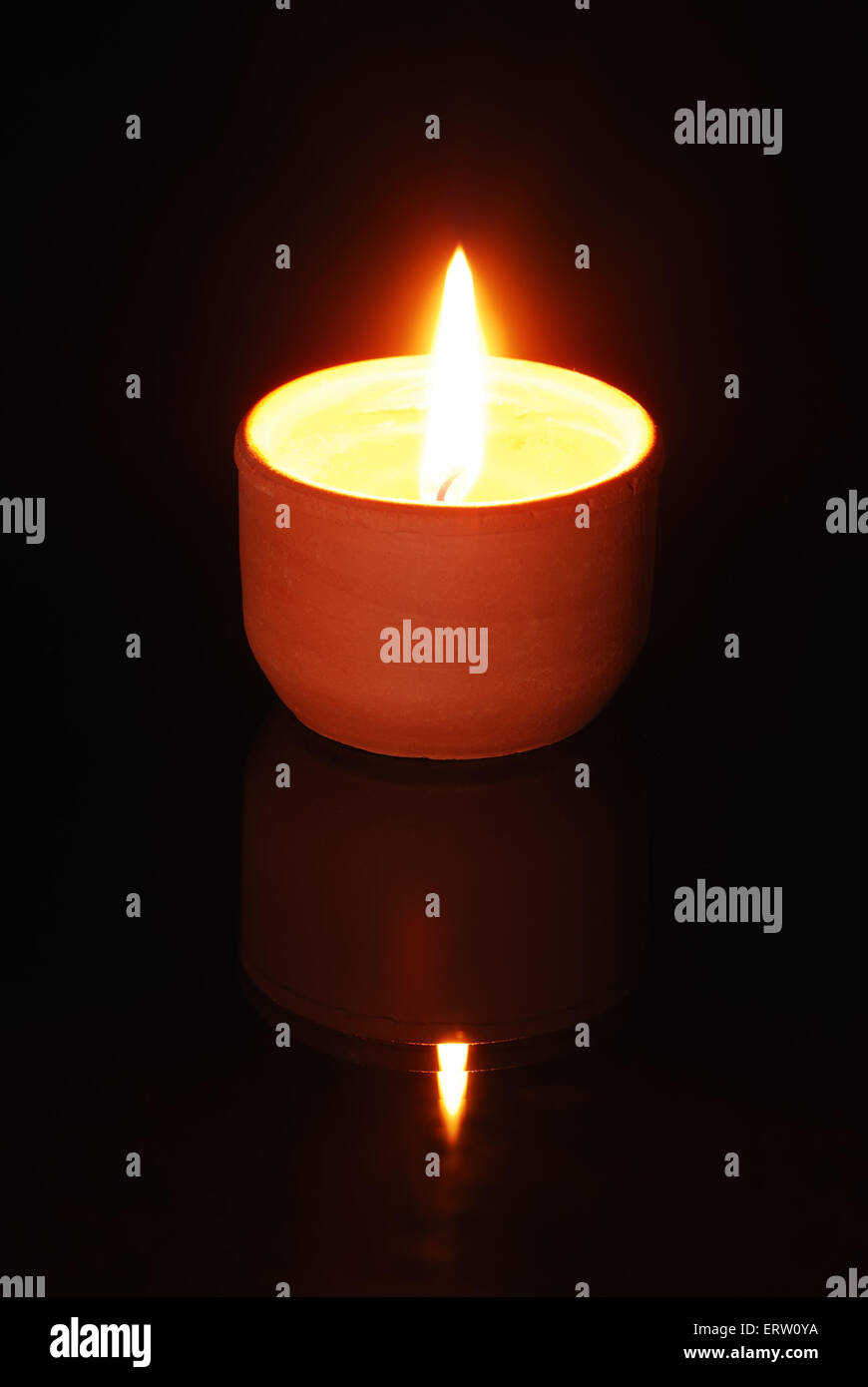 One burning candles on black background Stock Photo - Alamy