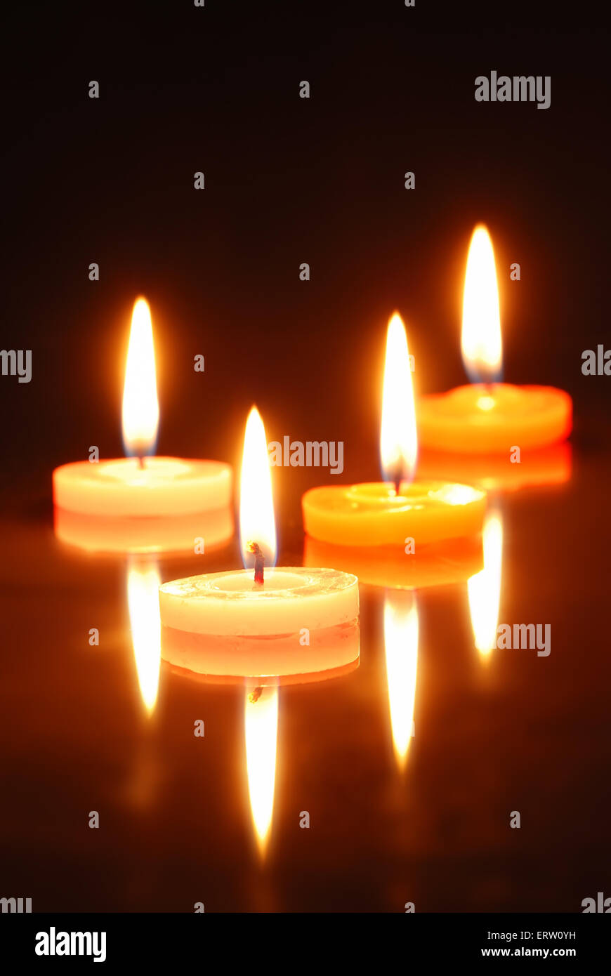 Closeup of burning candles isolated on black background Stock Photo - Alamy