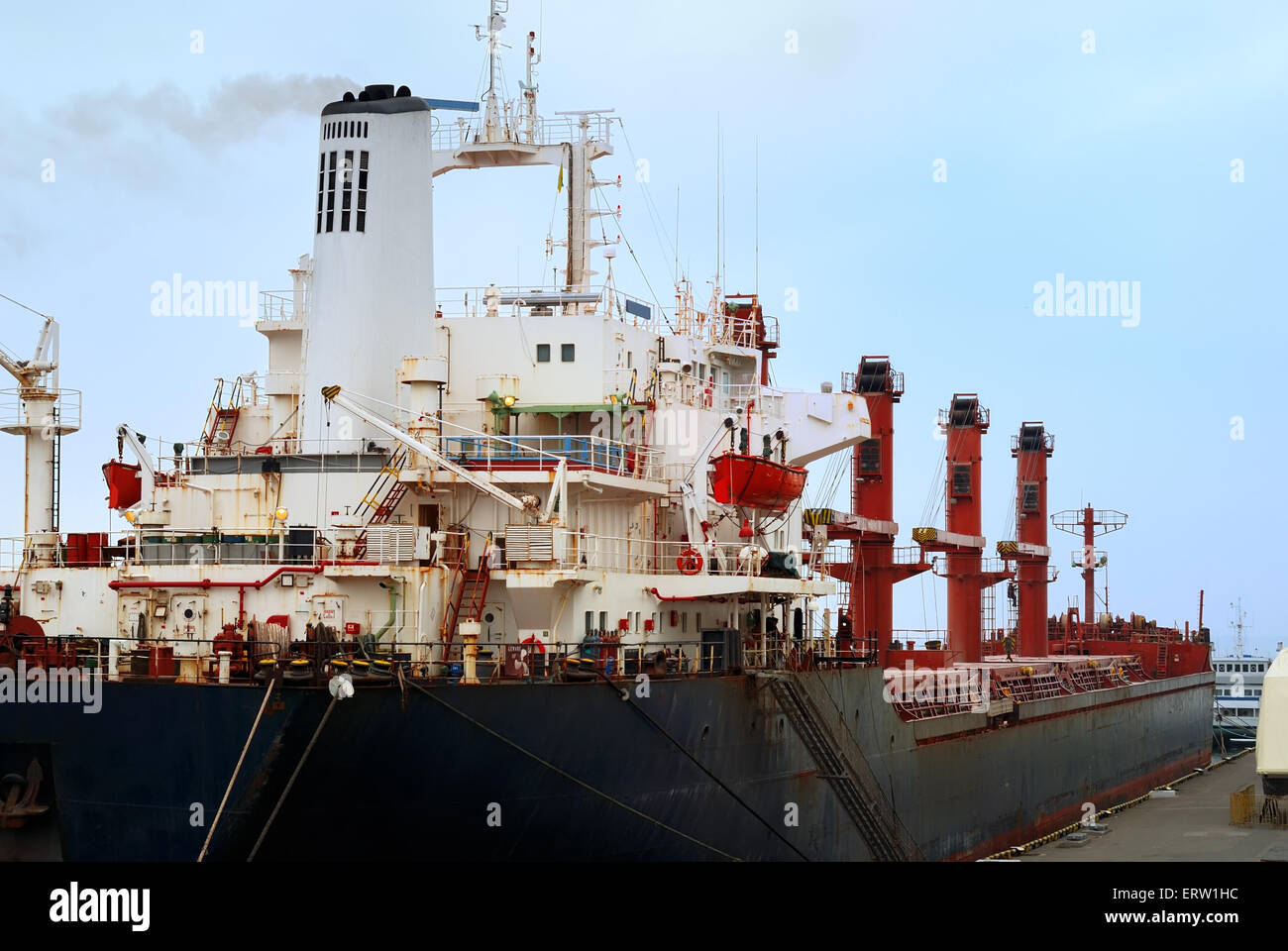 The commercial vessel is moored in port Stock Photo