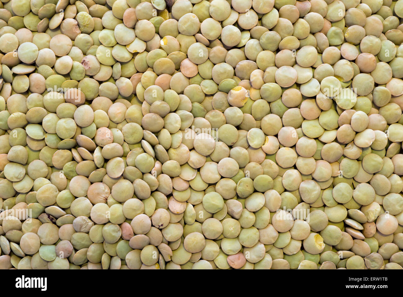 many dry green lentil seeds background Stock Photo