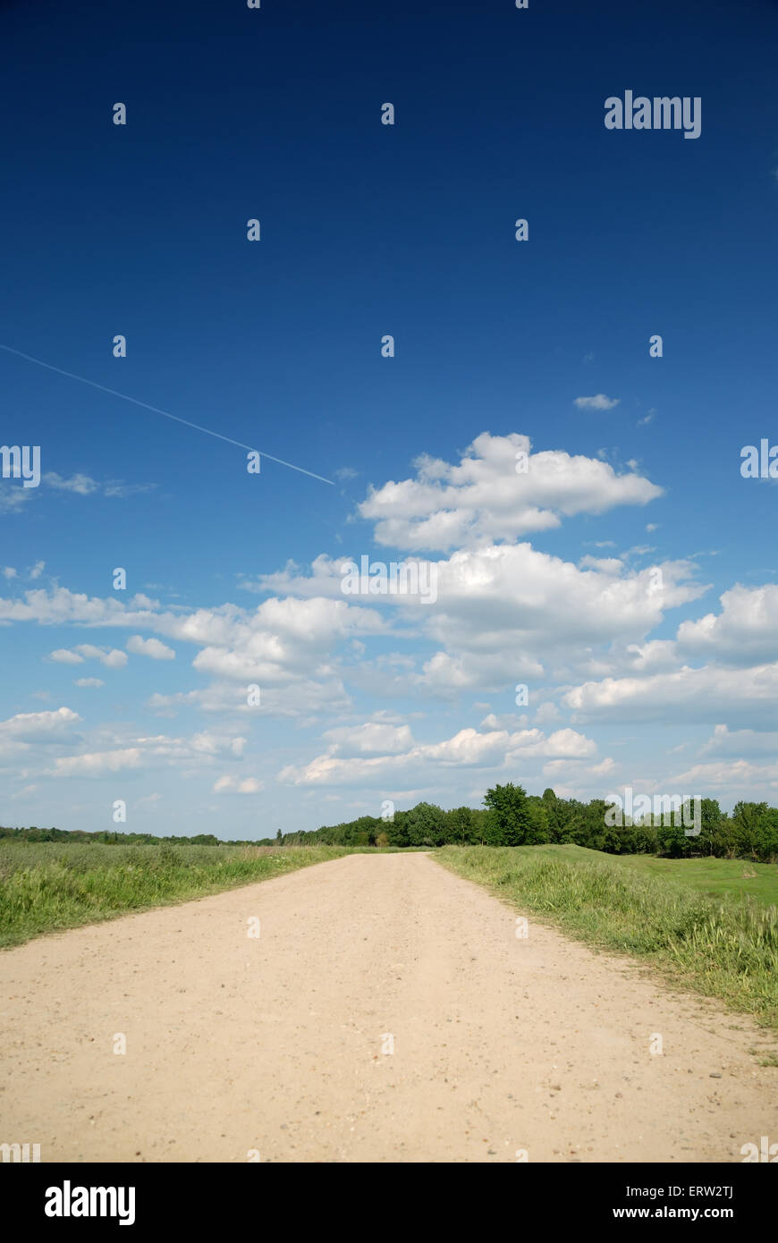 Midday summer landscape with road and highly flying plane Stock Photo ...