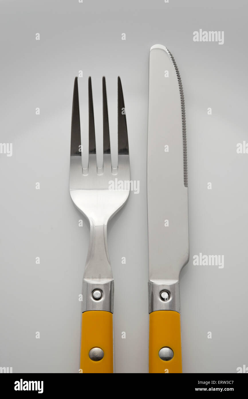 closeup scene with fork and knife on the white plate Stock Photo