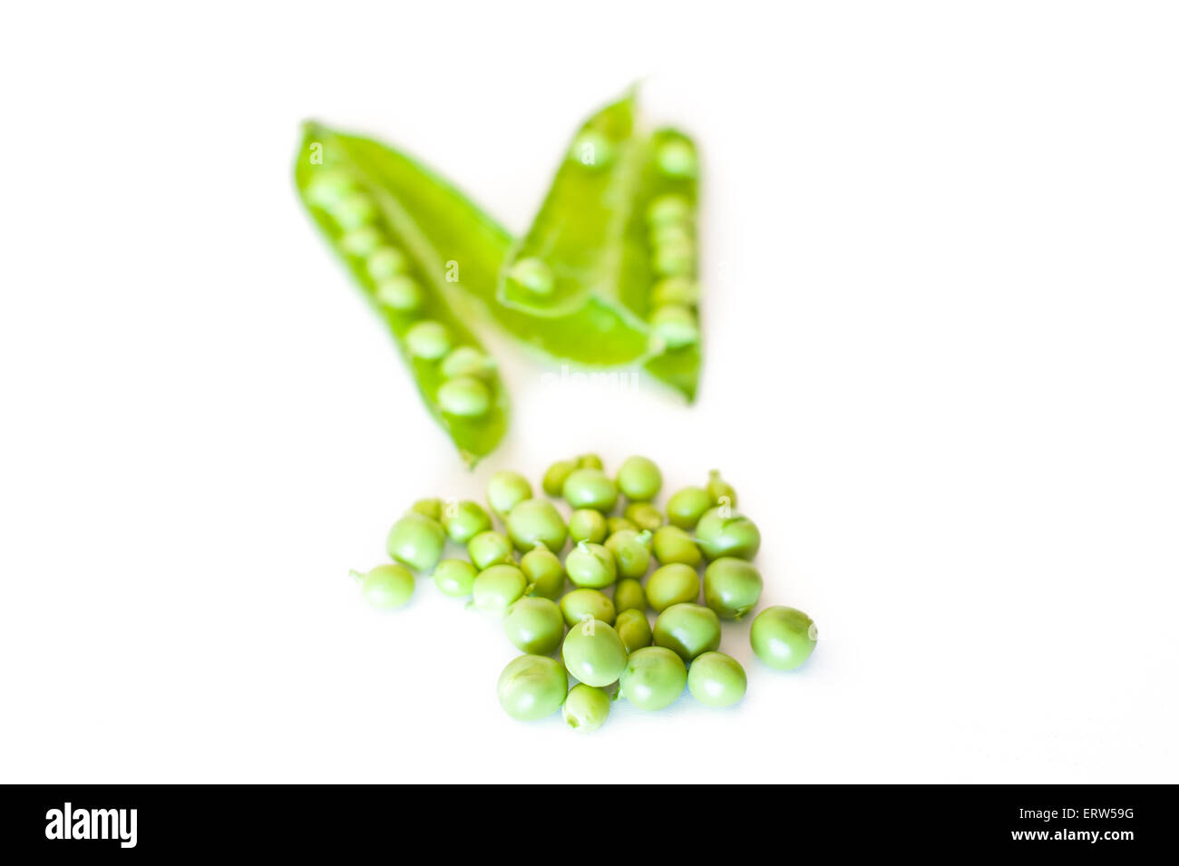 Fresh raw peas and pods isolated on white background selective focus Stock Photo