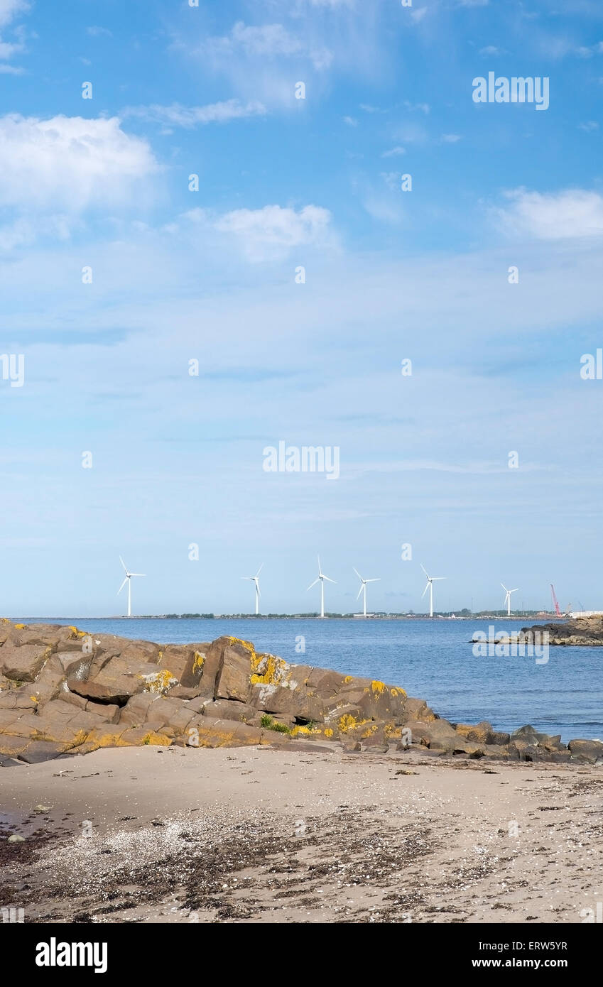 FALKENBERG, SWEDEN - JUNE 5, 2015: Wind turbines in rocky coastal ocean landscape by ocean on June 5 in Falkenberg, Sweden. Stock Photo
