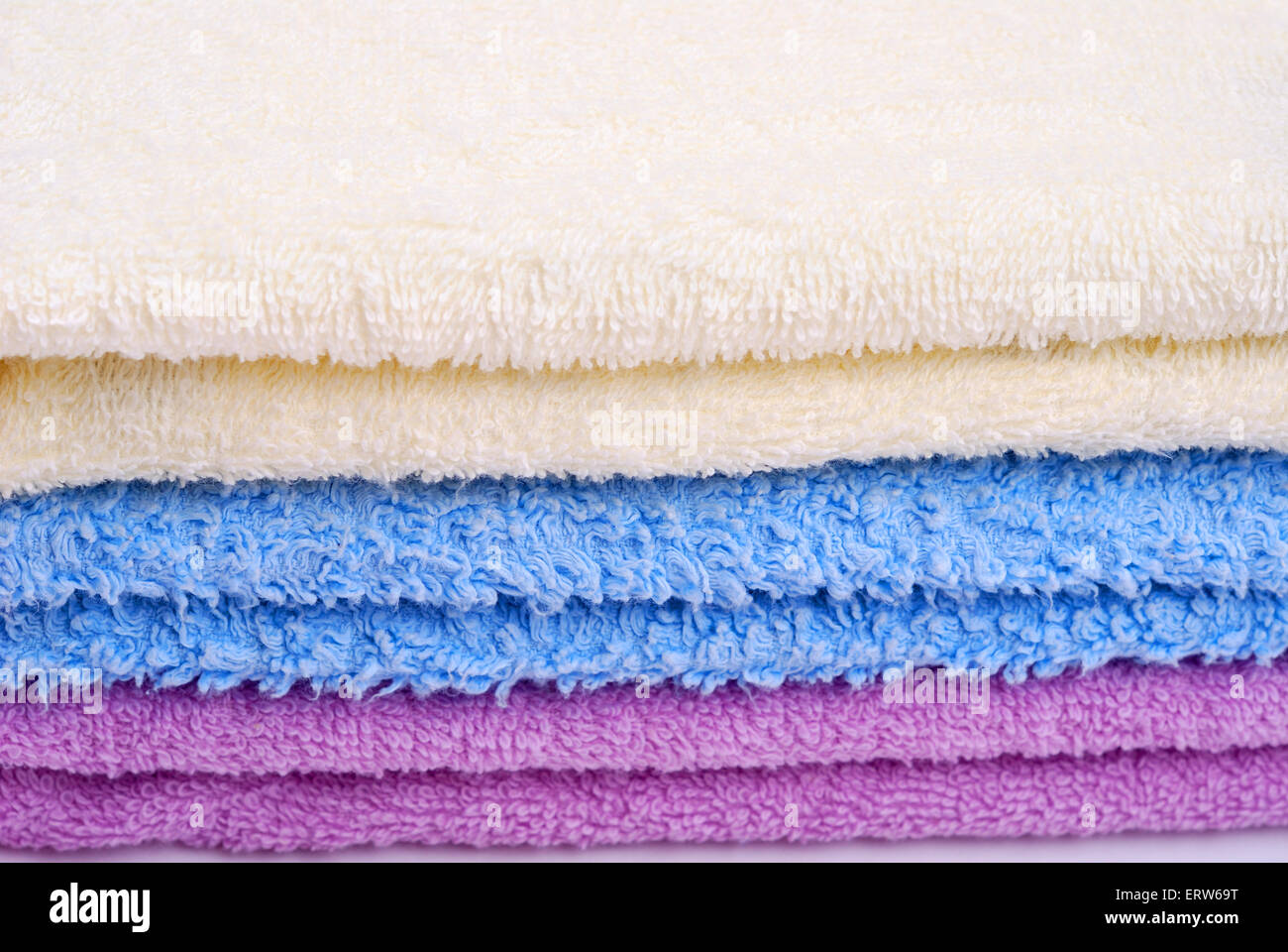 Stack of colorful towels on a white background Stock Photo - Alamy