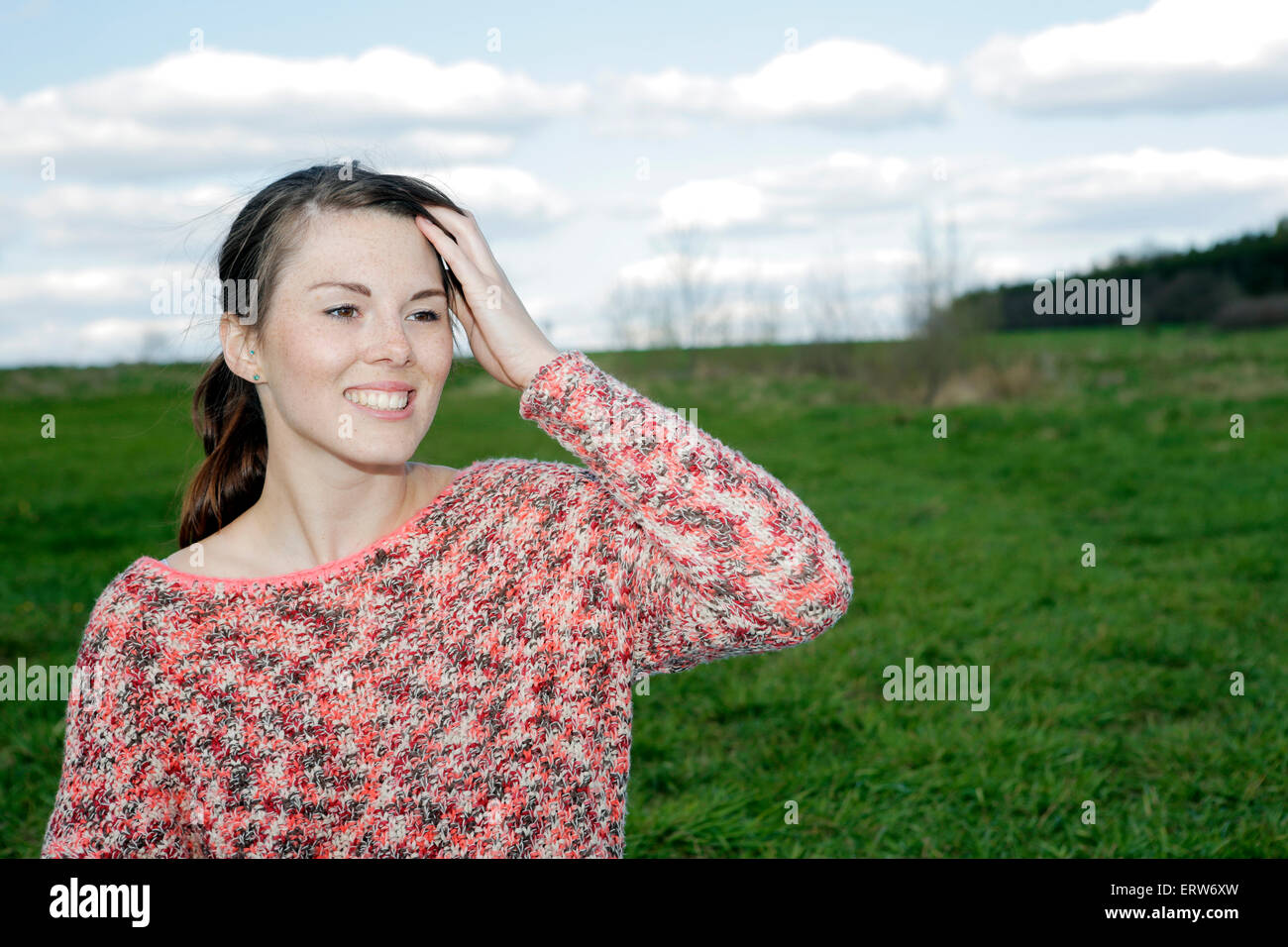portrait of young woman standing in a field of grass Stock Photo - Alamy