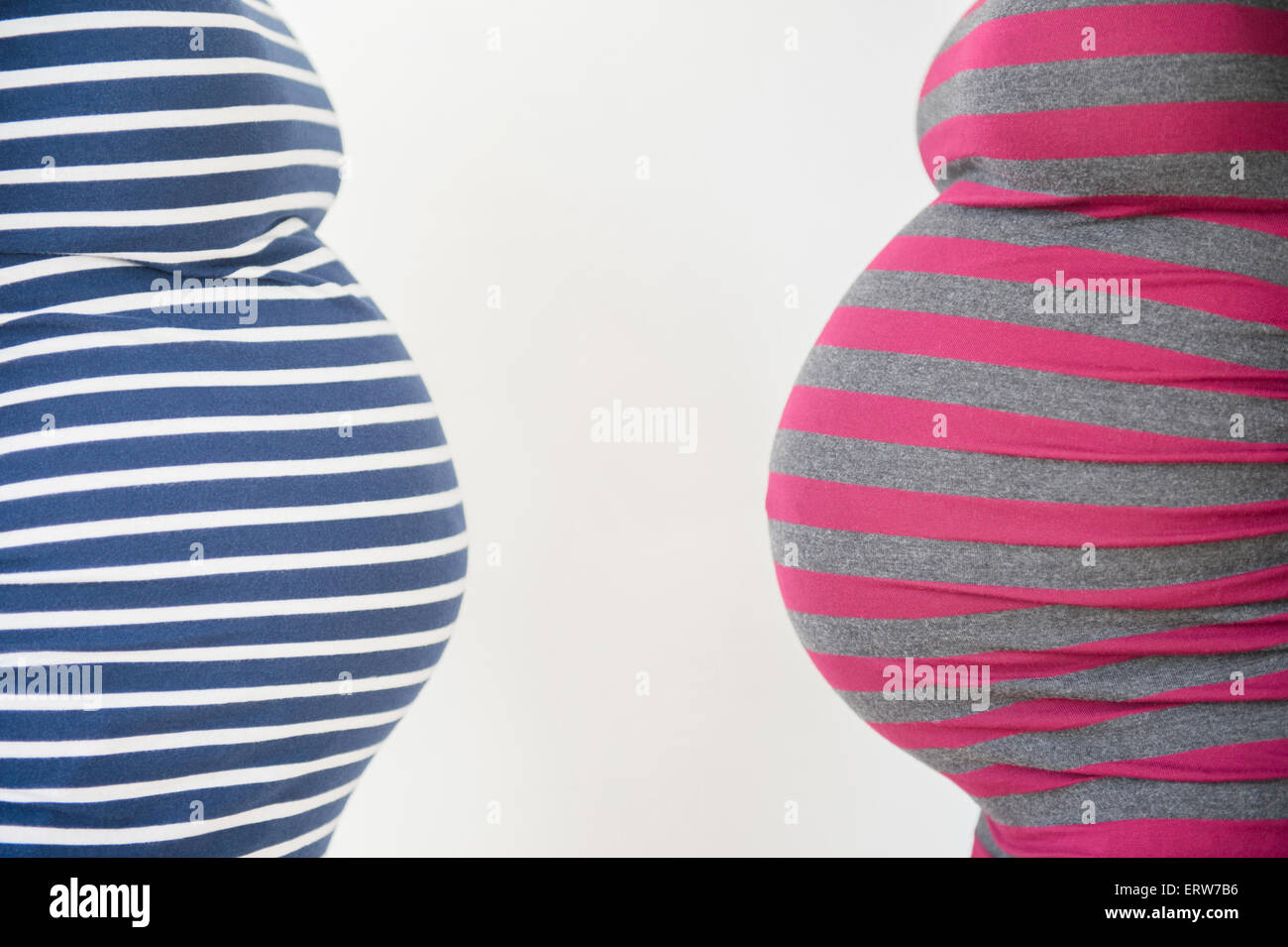 Close up midsection profiles of stomachs of pregnant women Stock Photo