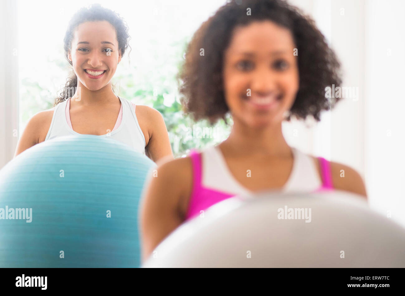 Women working out with fitness balls in exercise class Stock Photo